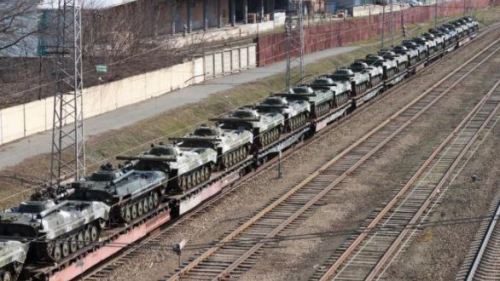 Rail cars carrying armored vehicles
